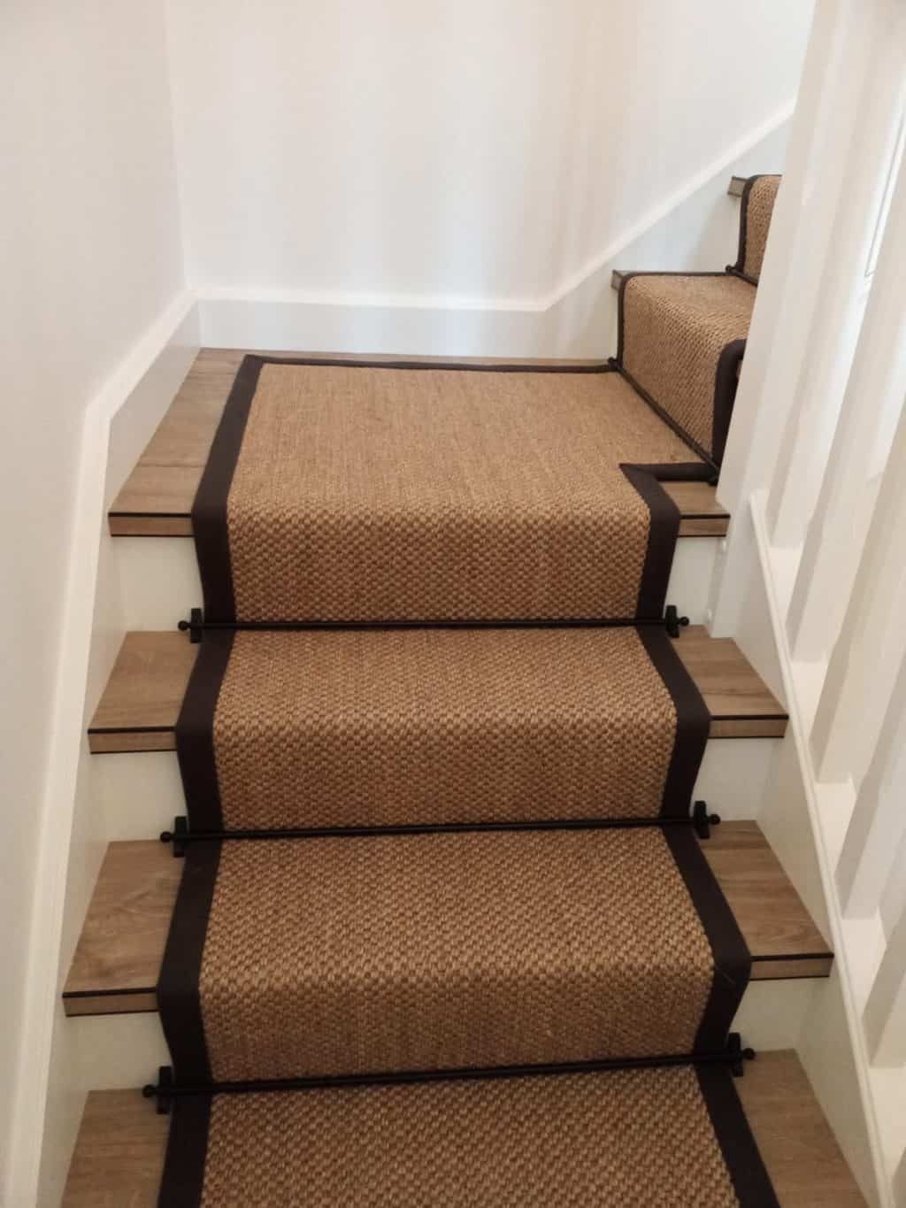 A sisal carpet stair runner by alternative flooring with black binding